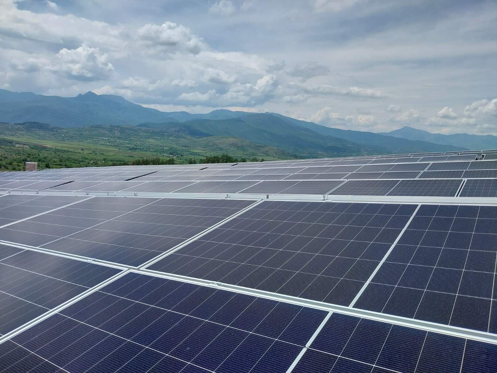 Solar panels installed against a mountain backdrop